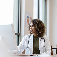 female medical worker sitting down at computer