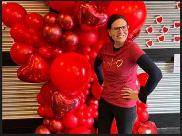 Danielle posing with red balloons