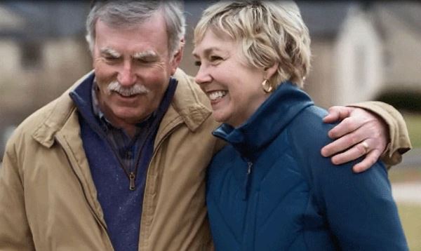 Gail Hogan and her husband walk outdoors