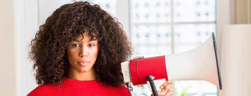 Woman in red shirt holding a megaphone