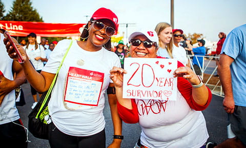 two women at heart walk smiling for the camera