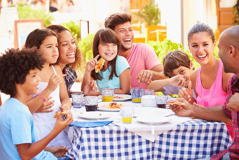 multi-ethic family eating meal at home