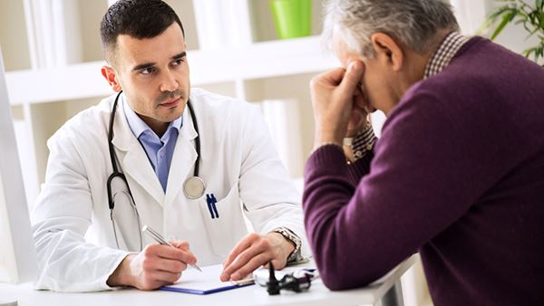 worried  older man talking to doctor