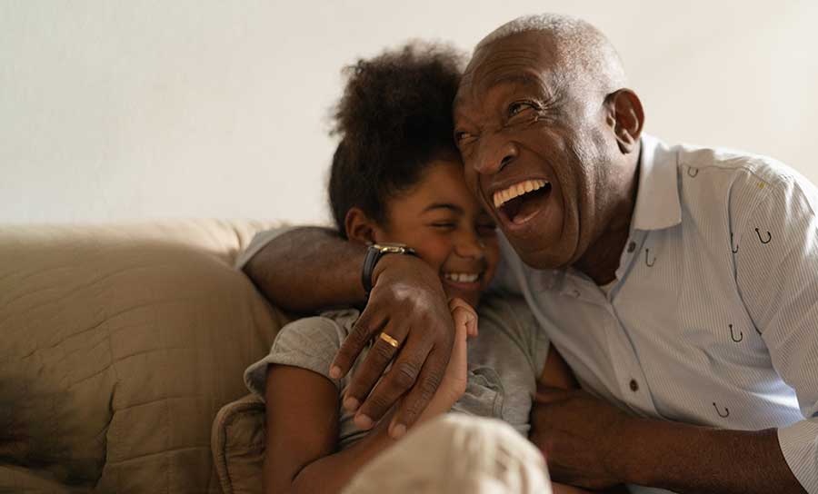 really happy grandpa smiling and laughing with granddaughter