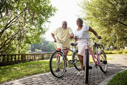 Senior couple riding bikes outdoors