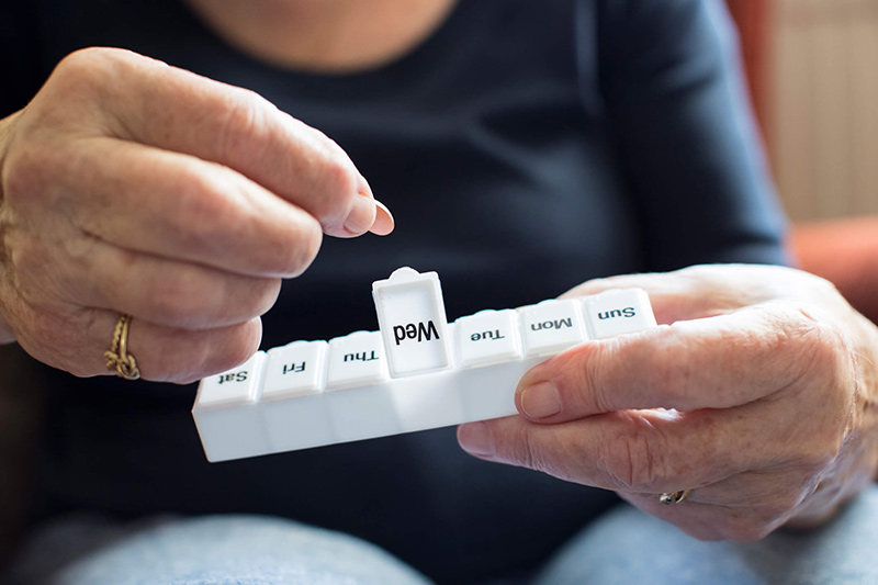 person sorting pills