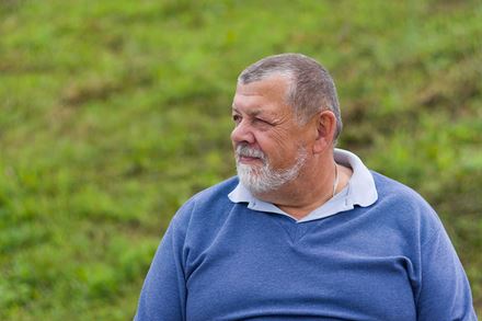 senior man with beard walking