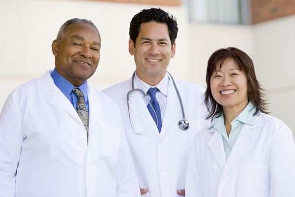 Three doctors smiling