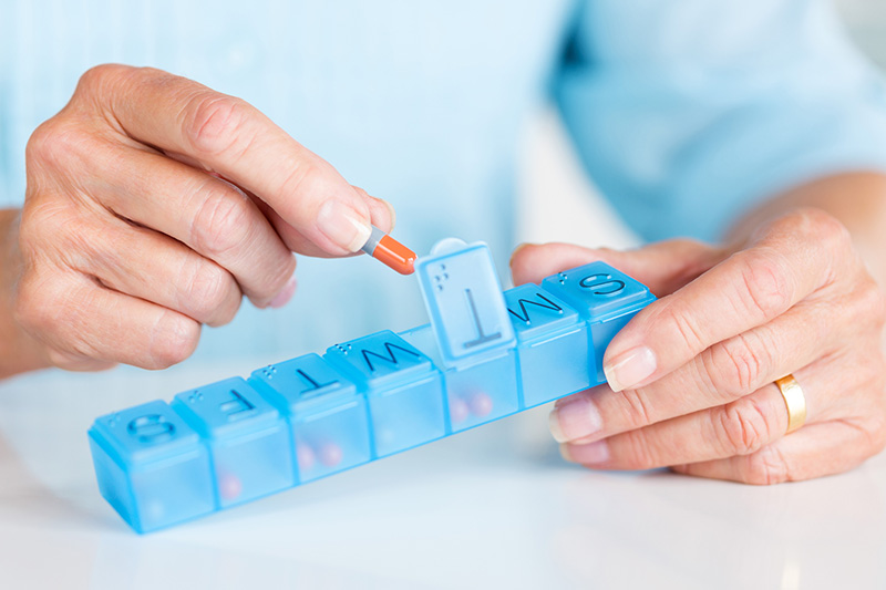 man sorting pills